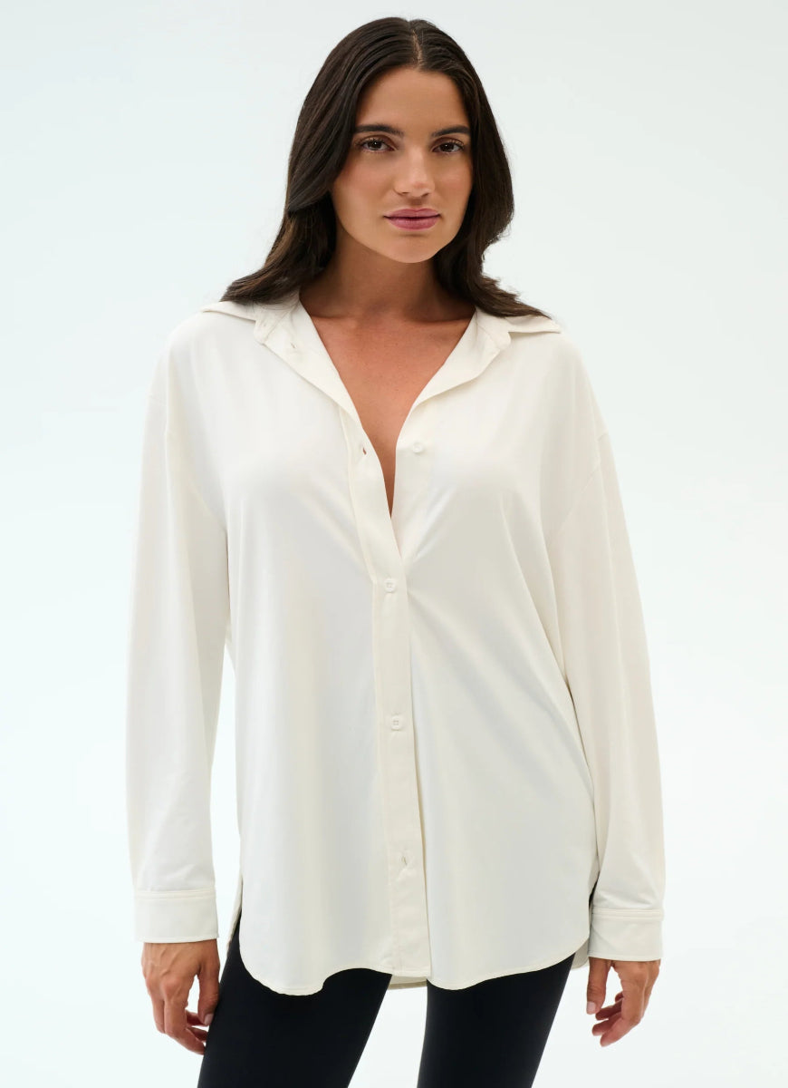 Woman wearing a white blouse with a plain background