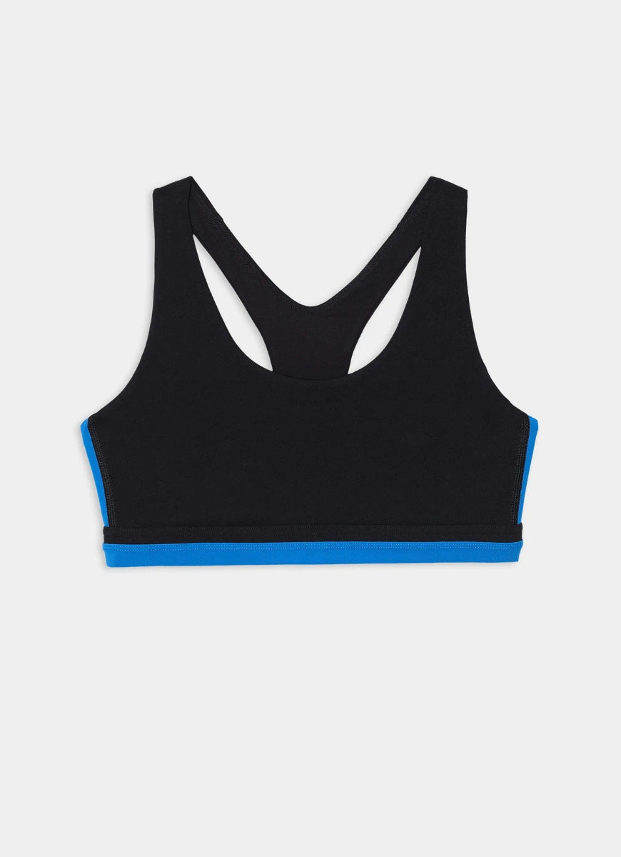 A black racerback sports bra with a bright blue accent band along the underbust and bottom hem, displayed flat against a light gray background.