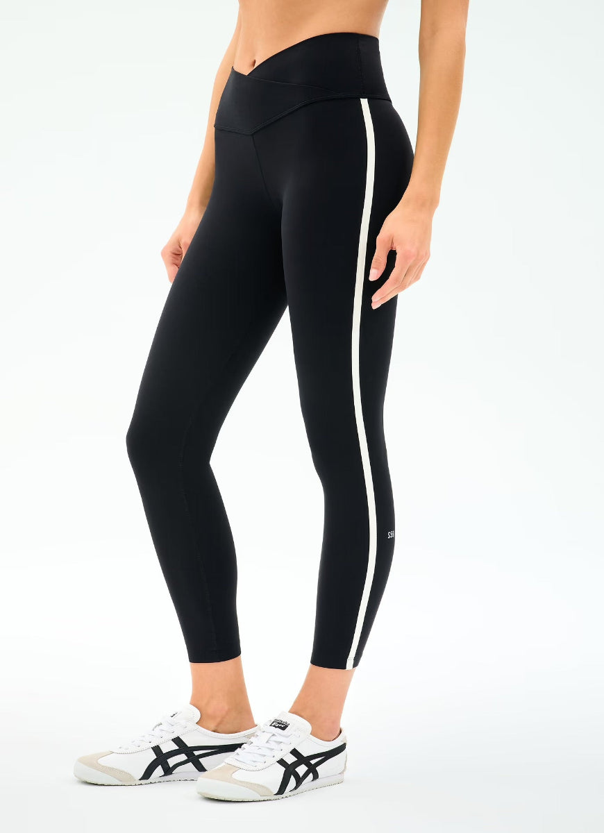 Black leggings with a white stripe on a white background