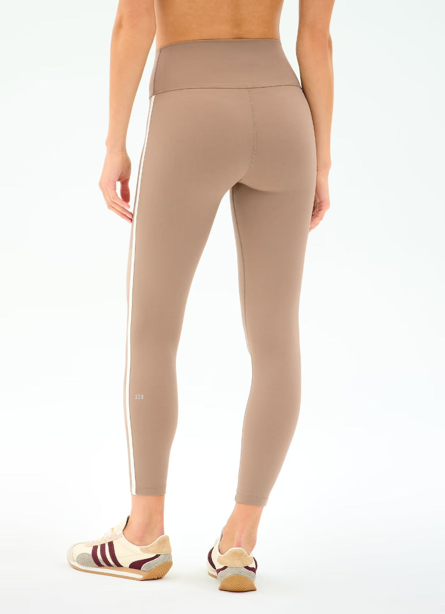 Beige leggings worn by a person on a white background