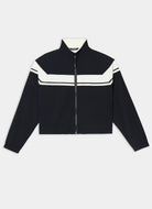 A cropped black zip-up jacket with contrasting white stripe details across the chest and shoulders, displayed flat against a light gray background.
