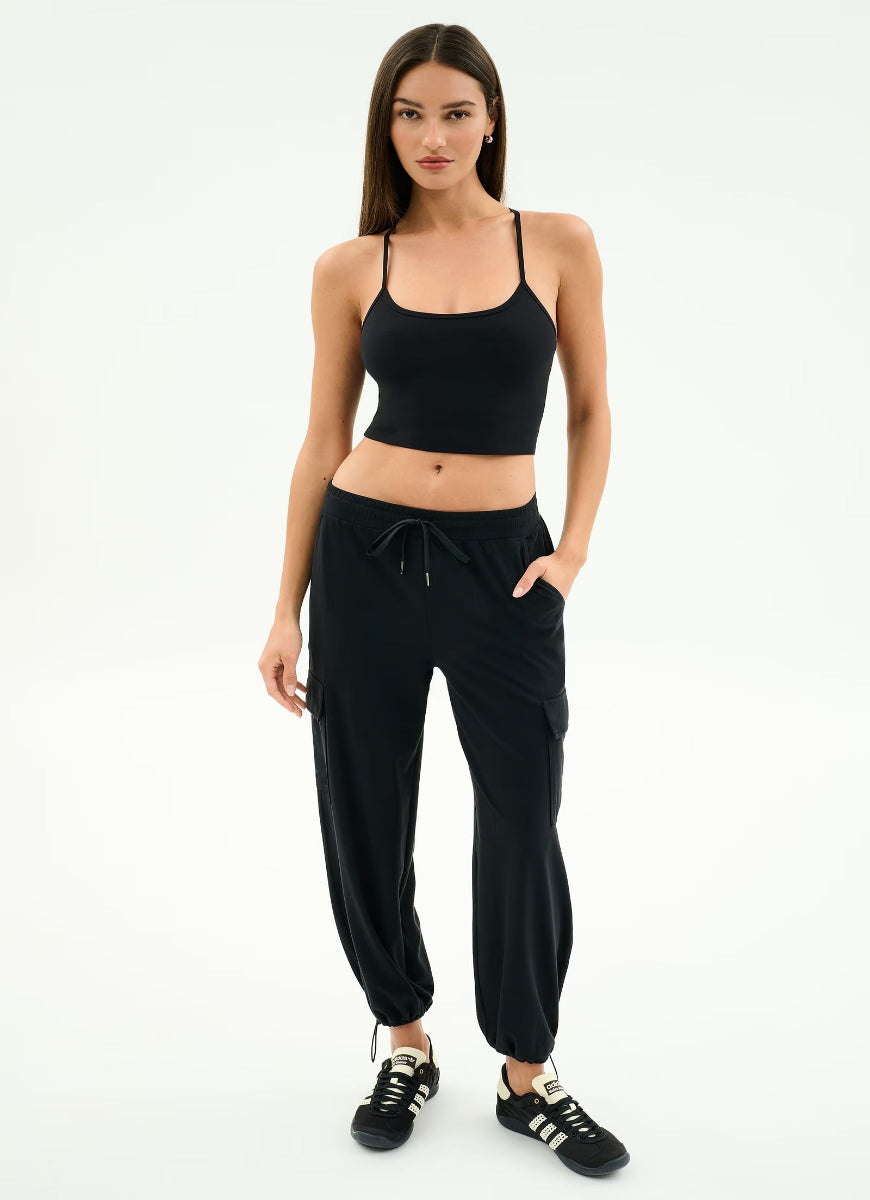 Woman wearing a black athletic outfit on a white background