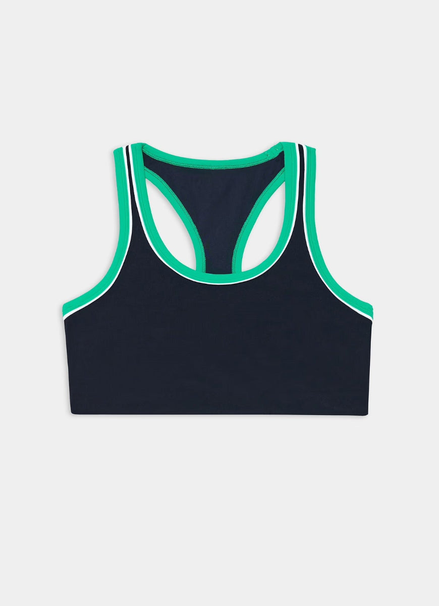 Black sports bra with green trim on a light gray background