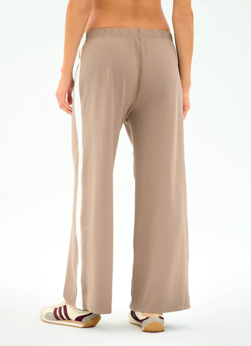 Beige wide-leg pants worn by a person on a white background
