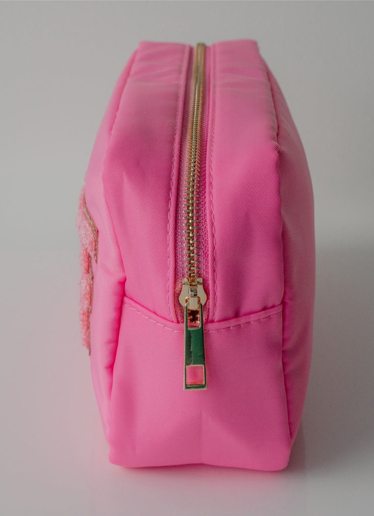 The STUFF Pouch Cosmetic Travel Bag in Bubblegum/Pink Side View Showing Gold Zipper