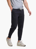 vuori Men's Sunday Performance Jogger in Black Side View with Hand in Pocket