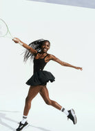 Free People Swing Of Things Dress in Black Model Jumping With a Tennis Racquet 