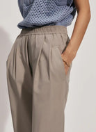 Varley Tacoma Straight Pleat Pant 28" in Cinder Close Up Side View with Hand in Pocket
