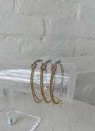 Lo & Co The Knot Bracelet Shown on Clear Stand