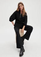 Varley Davidson Sweat Half Zip in Black Front View With Model Sitting on a Stool