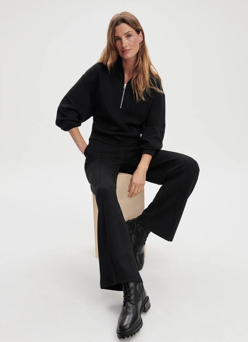 Varley Davidson Sweat Half Zip in Black Front View With Model Sitting on a Stool