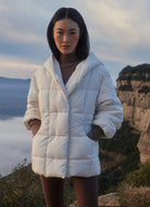 Varley Kaia Quilted Coat in Jet Stream Front View Model With Hands in Pockets