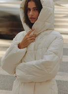 Varley Kaia Quilted Coat in Jet Stream Front View With Hood Up
