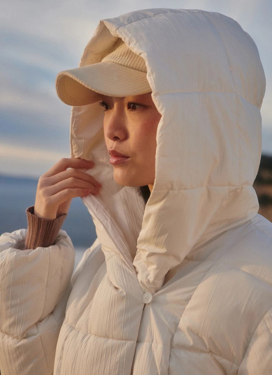 Varley Kaia Quilted Coat in Jet Stream Close Up Side View With Hood Up