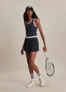 Varley Tegan Performance Tank inBlue Nights Full Length View With Model Shown Holding a Tennis Racquet.