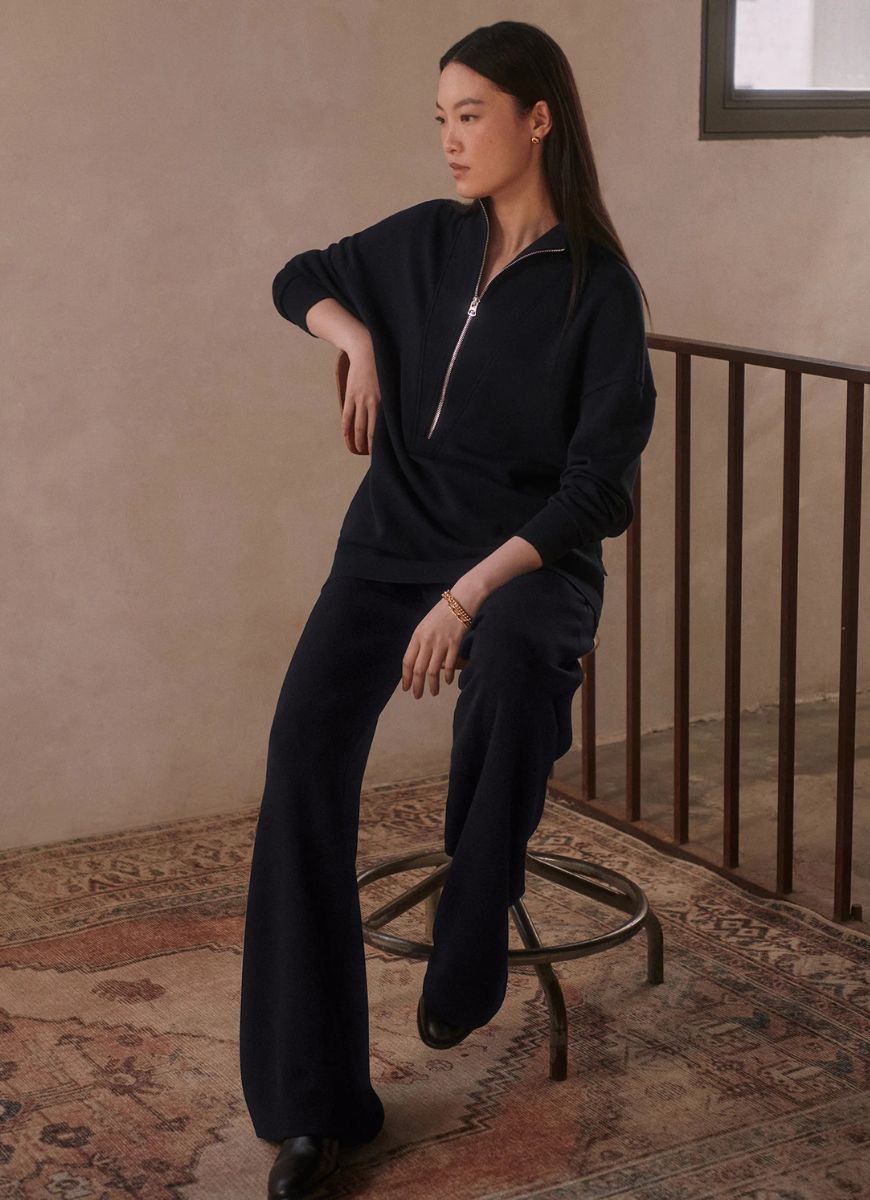 Varley The Extra Wide Leg Pant 29.5" in Navy Model Shown Sitting on a Stool