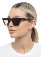 Le Specs Velodrome Women's Sunglasses in Black Shown on Model Side View