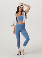 Vuori Daily Pocket Legging in Light French Blue Alternate Front View Model Wearing a Backwards Hat
