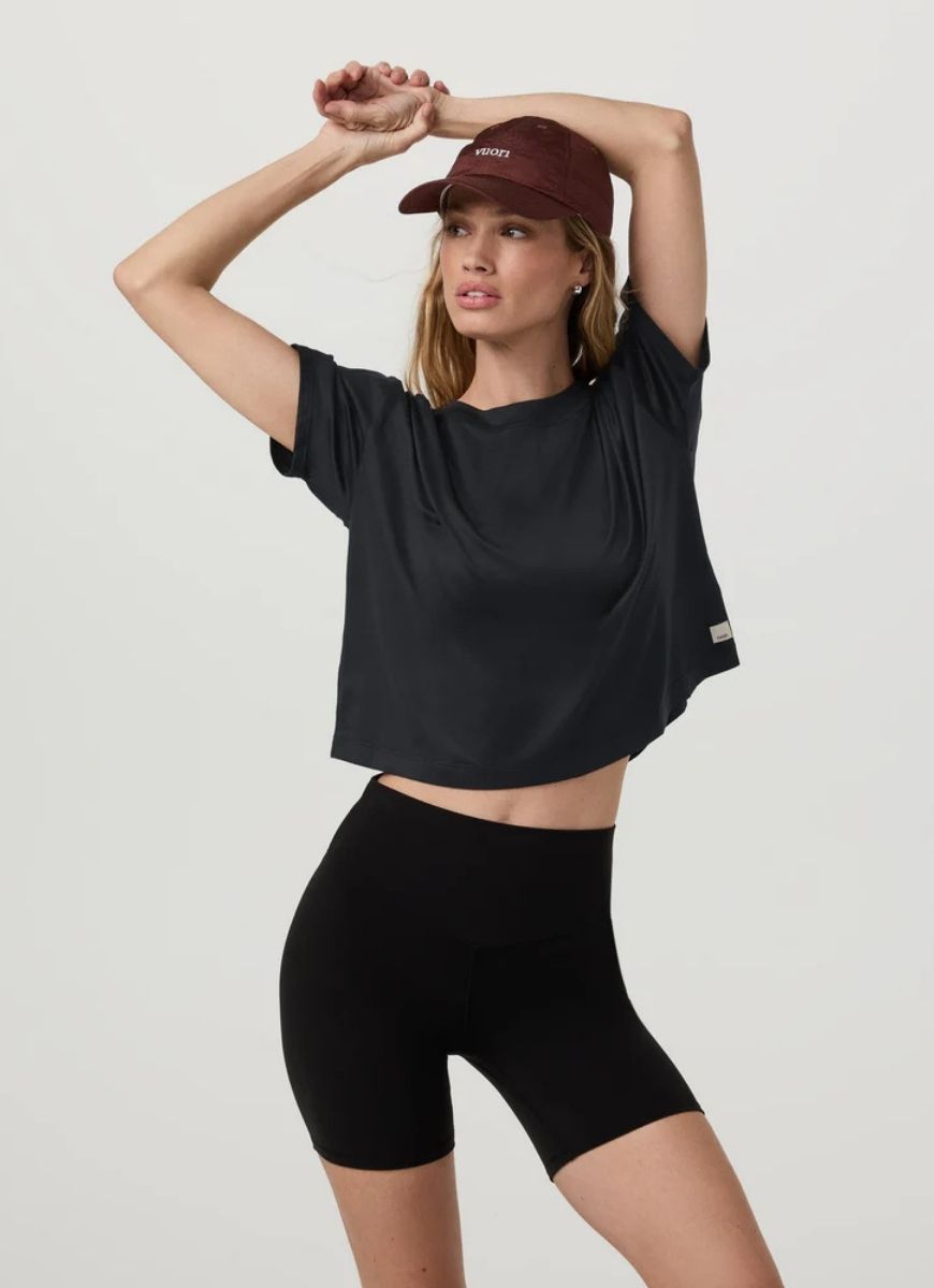 vuori Women's Energy Tee in Black Front View With Model in a Pose
