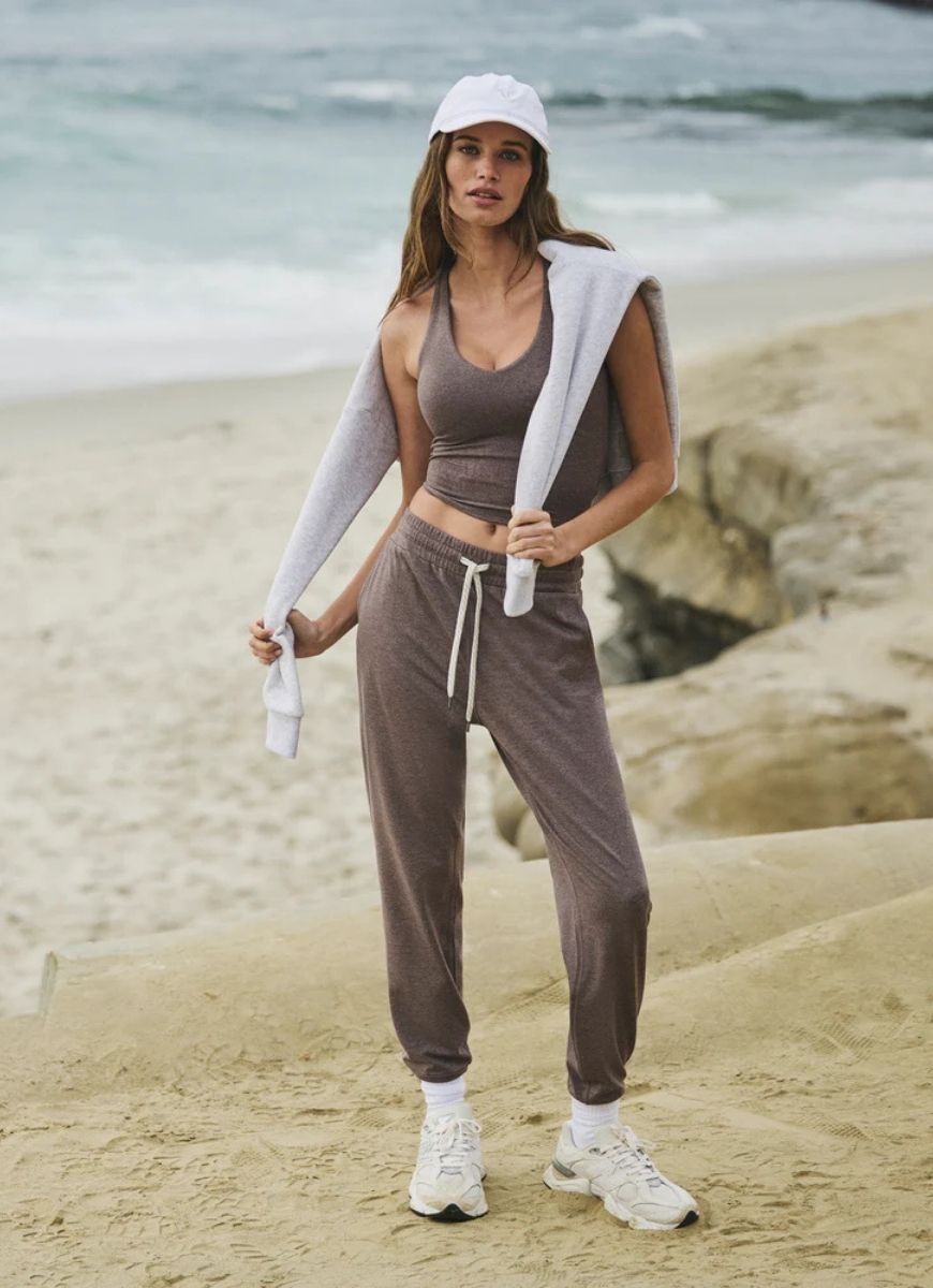 Vuori Women's Performance Jogger in Huckleberry Heather Front View With Model on the Beach