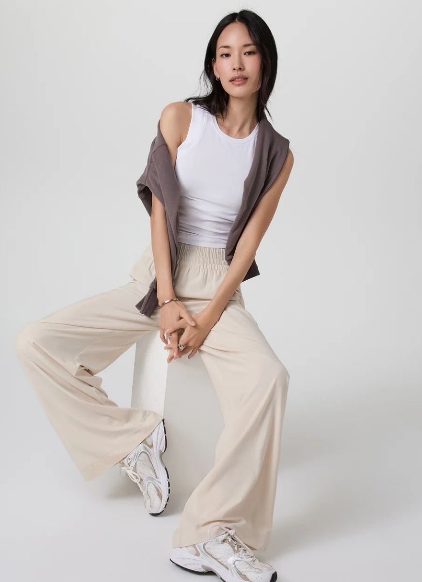 Vuori Villa Wideleg Pant in Milkweed Front View With Model Sitting on a Stool