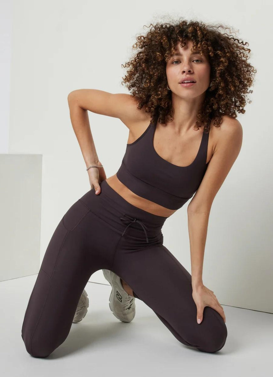 Vuori Yosemite Longline Sports Bra in Sangria Model Kneeling in a Pose