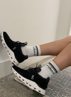 relevé Crew Socks in White with Black Logo Shown on Model