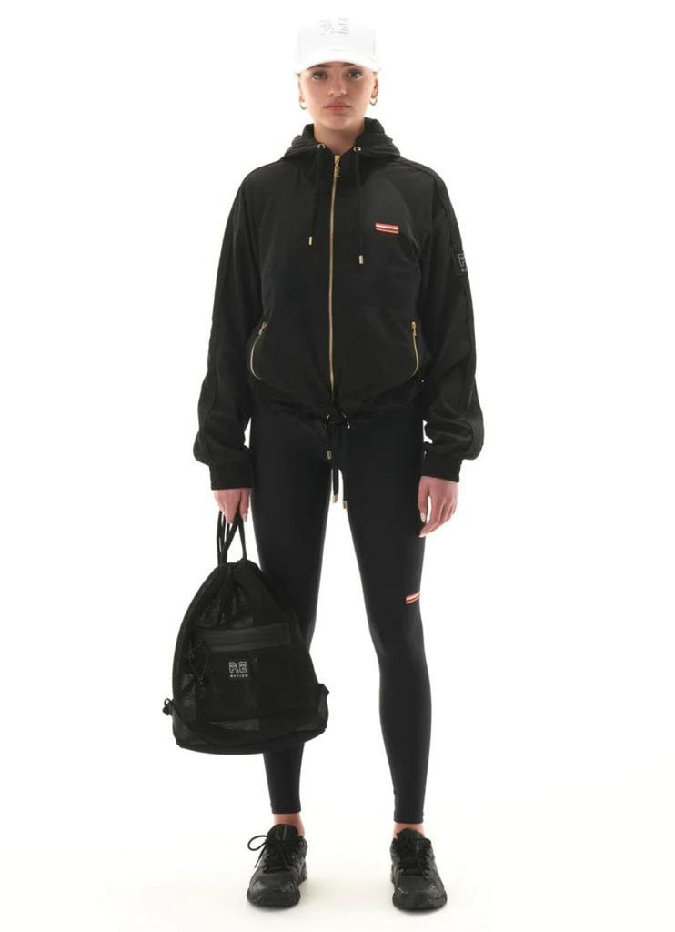 P.E Nation Endurance Man Down Women's Jacket in Black Front View with Model Holding a Bag