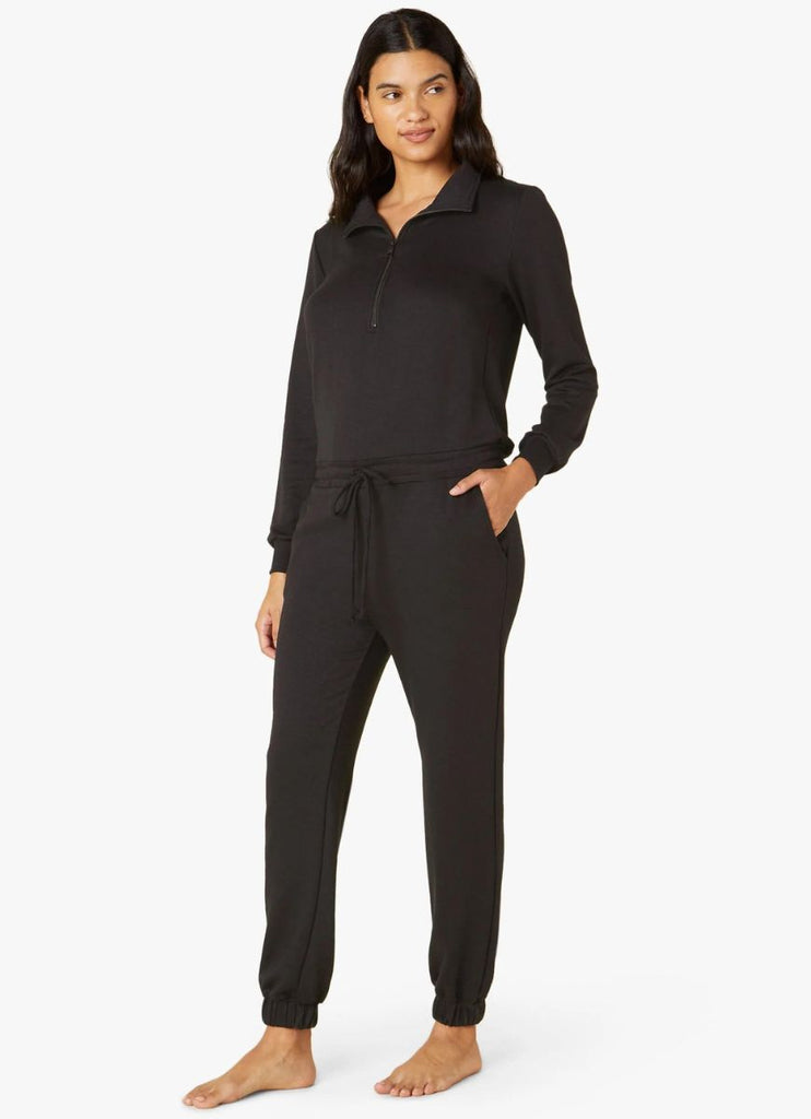 Beyond Yoga Women's Ski Weekend Jumpsuit in Black Angled Side View with Hand in Pocket
