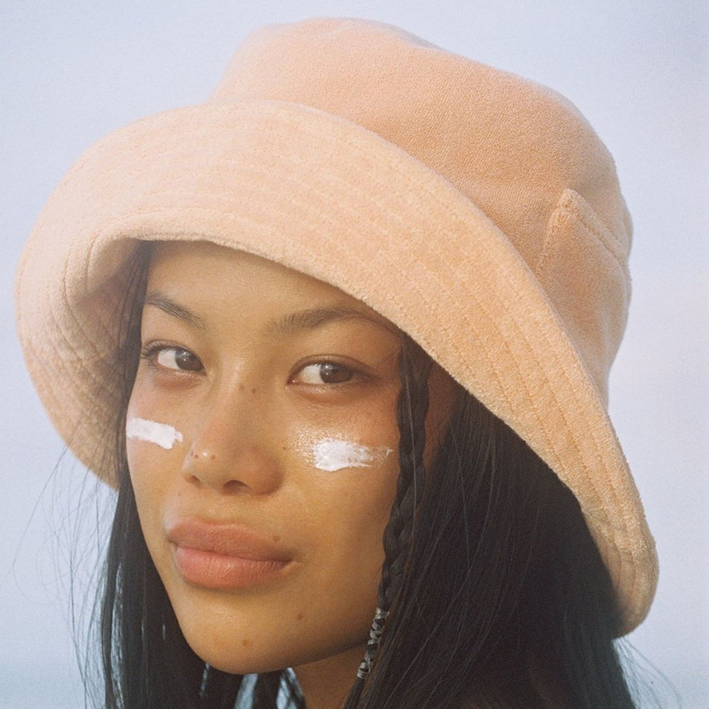 Lack of Color Wave Bucket Hat in Peach Terry on Model With Brim Flipped Up