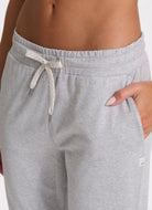 Vuori Women's Performance Jogger Long in Heather Grey Close Up Front View with Hand in Pocket